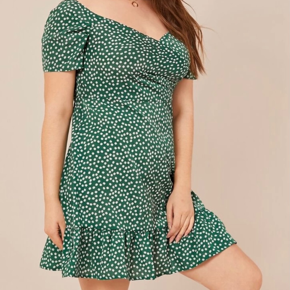 Green dress, white floral detail, ruffle hem.